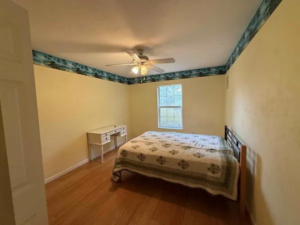 a bedroom with a bed and a chandelier