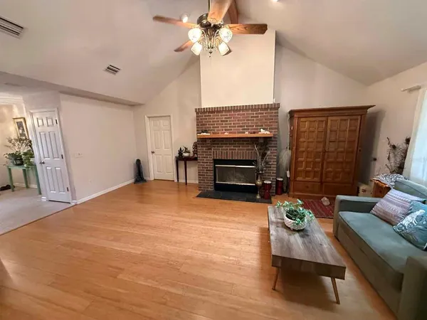 a living room with furniture a fireplace and a flat screen tv