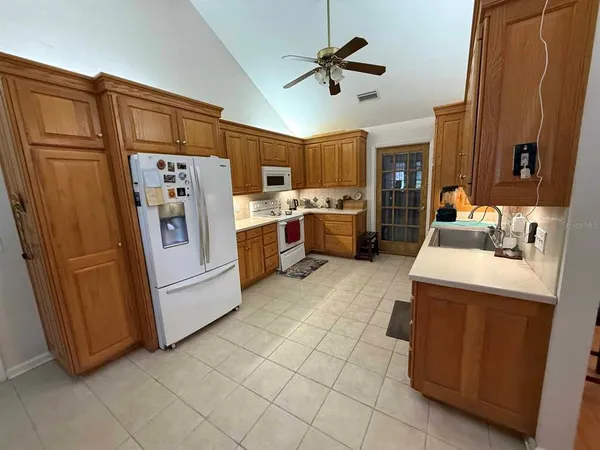 a kitchen with refrigerator and cabinets
