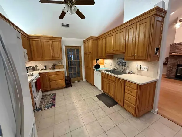 a kitchen with stainless steel appliances sink cabinets and window
