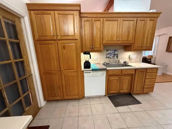 a kitchen with a refrigerator a sink and cabinets