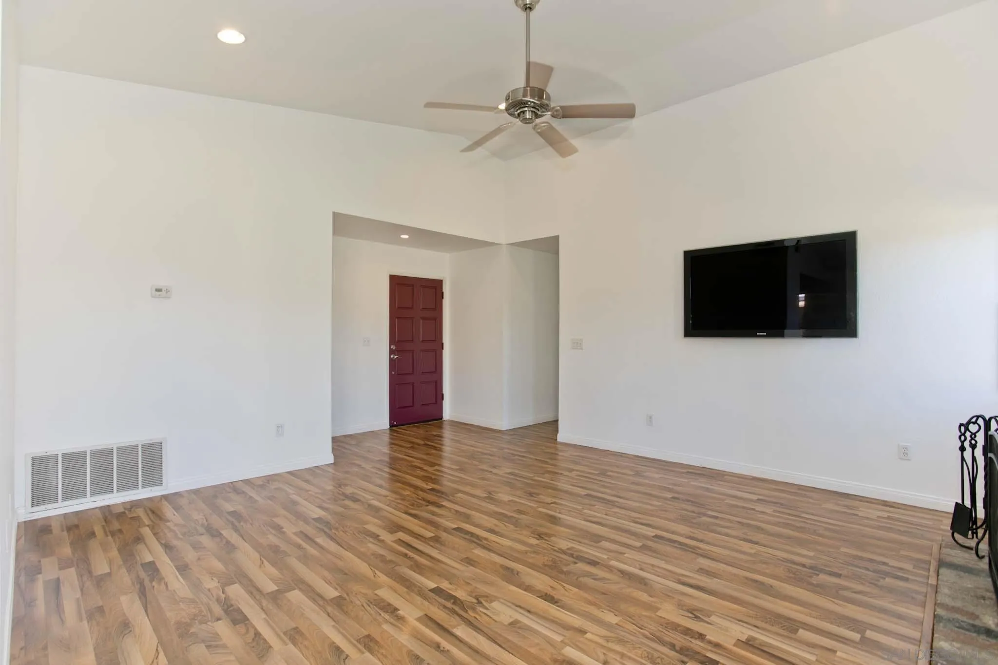 10076 West Glendon Circle Santee, CA 92071 - Photo 13 of 35 a view of an empty room with wooden floor and a ceiling fan