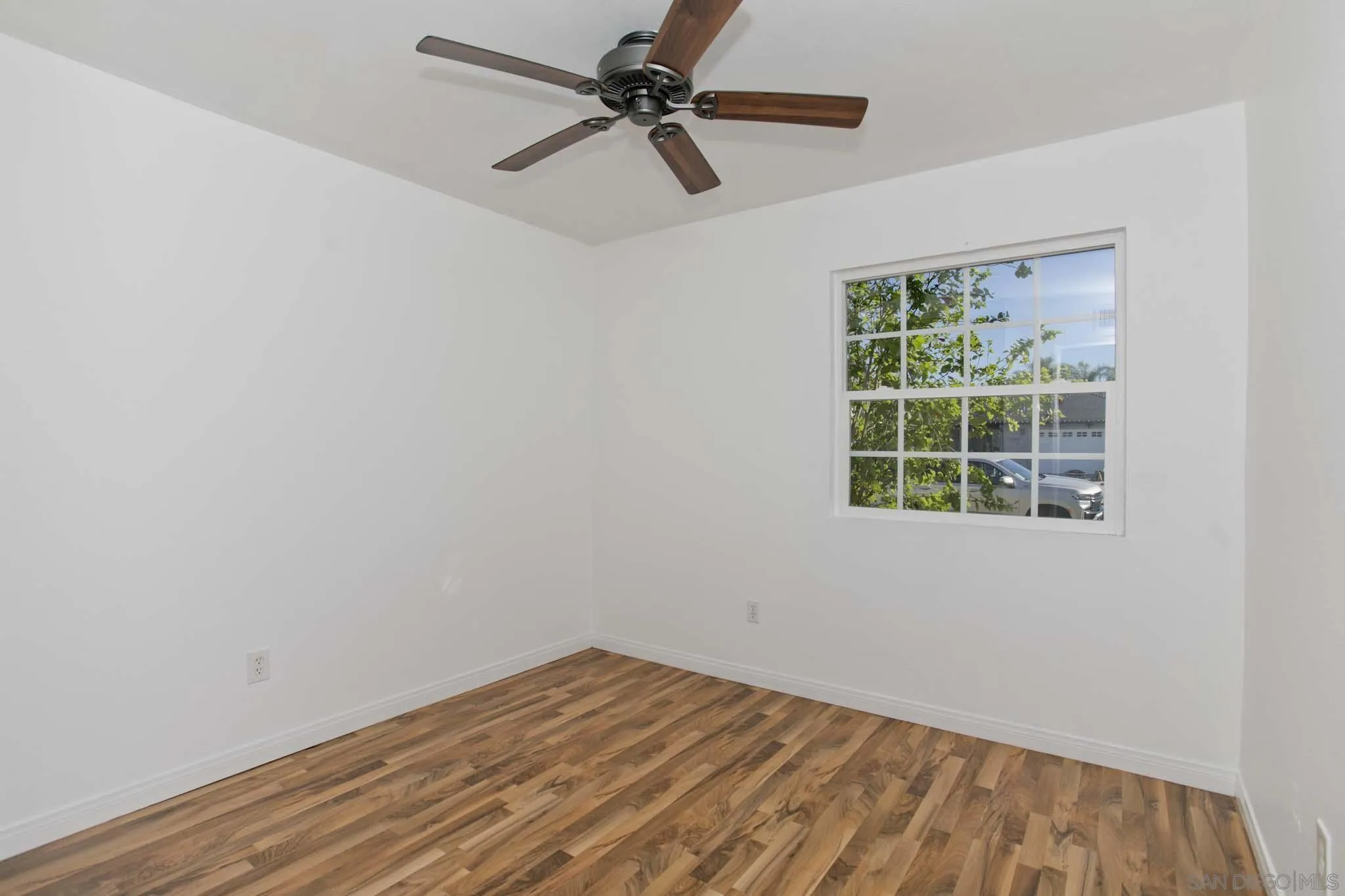 10076 West Glendon Circle Santee, CA 92071 - Photo 15 of 35 an empty room with a window and a fan