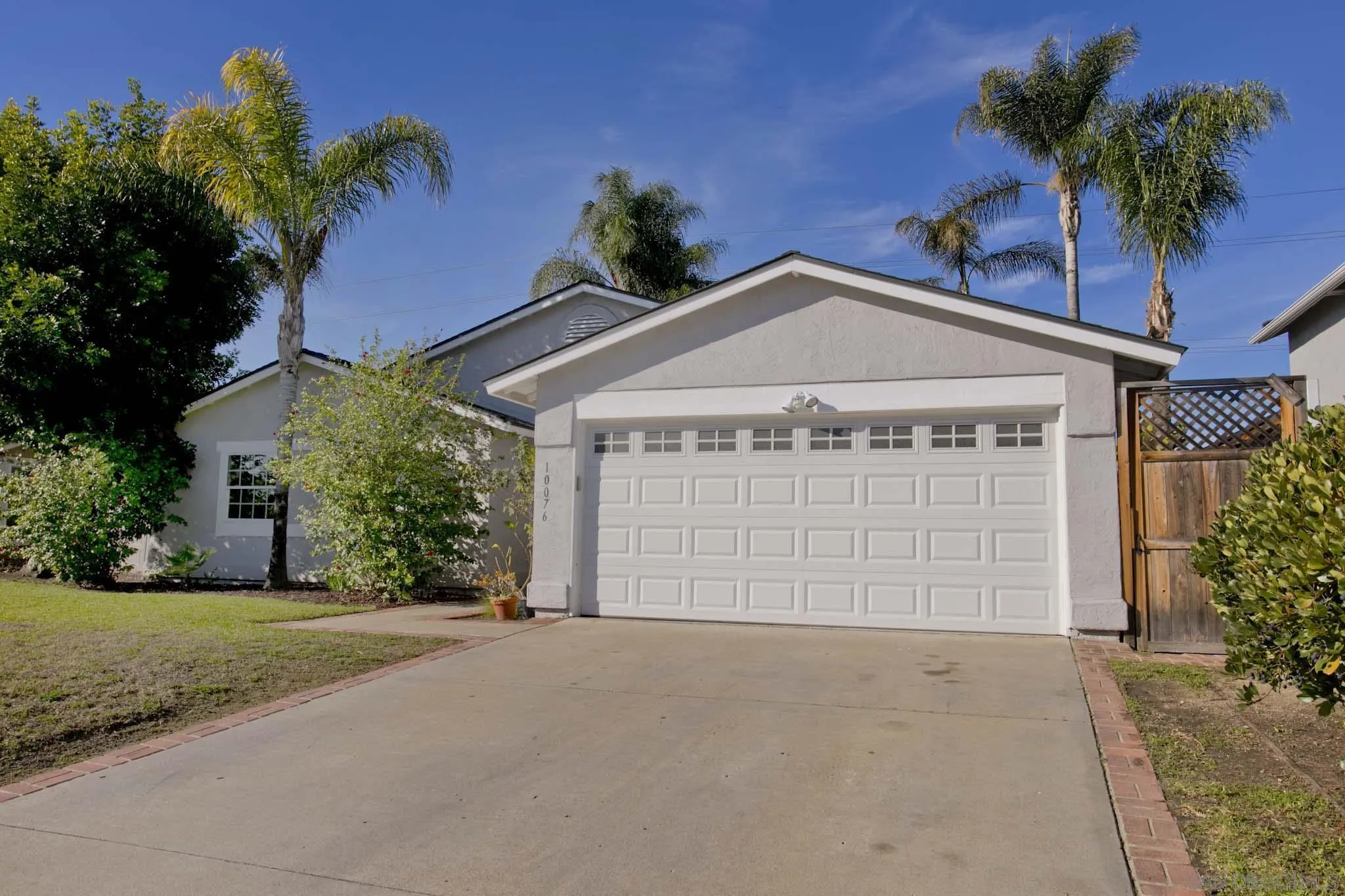 10076 West Glendon Circle Santee, CA 92071 - Photo 2 of 35 front view of a house with a yard and a garage