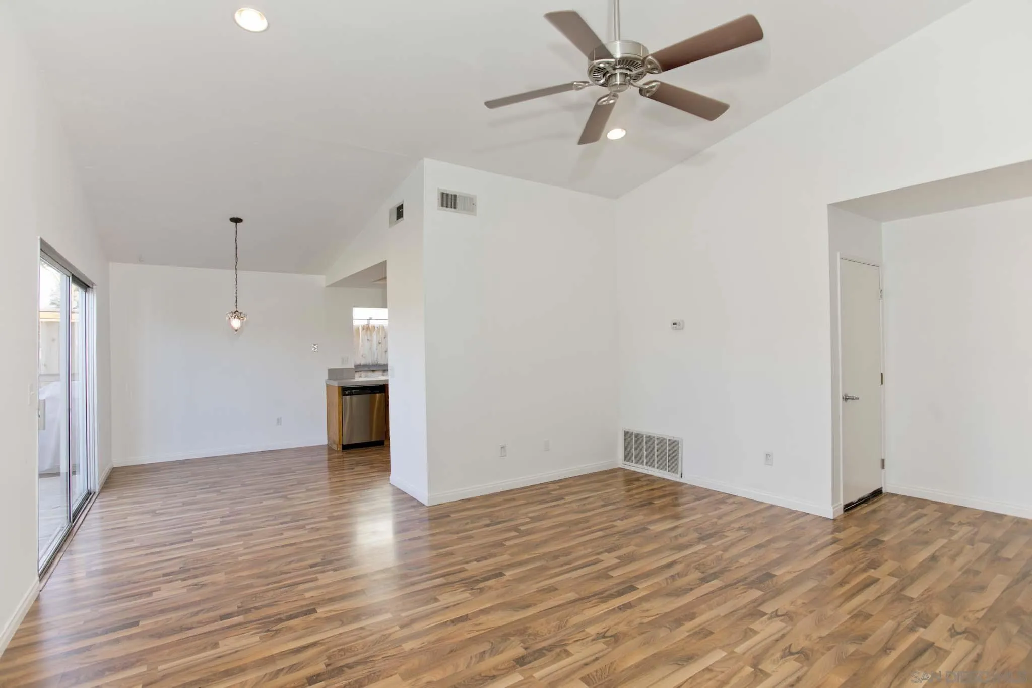 10076 West Glendon Circle Santee, CA 92071 - Photo 6 of 35 a view of empty room with wooden floor and ceiling fan
