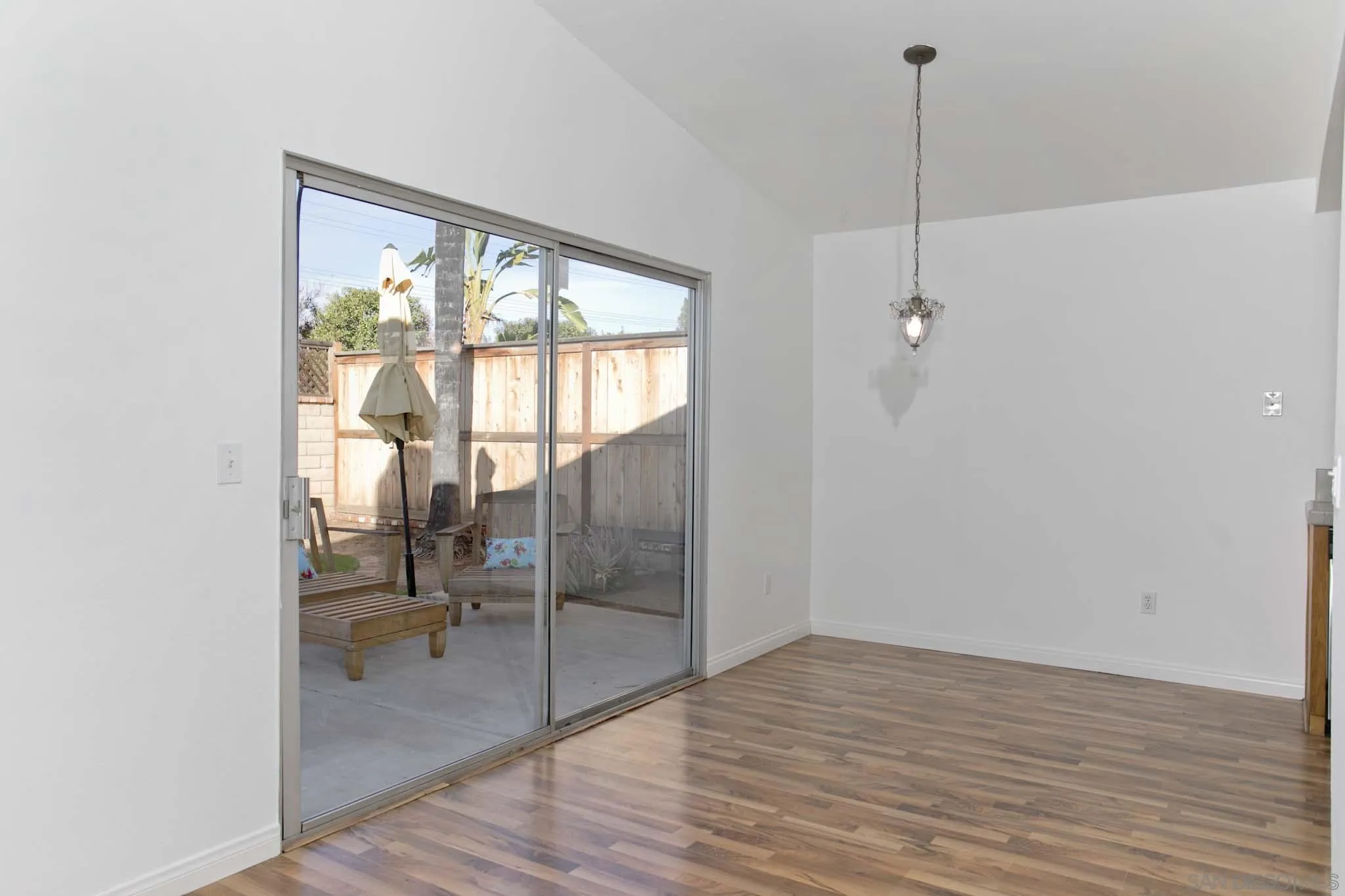 10076 West Glendon Circle Santee, CA 92071 - Photo 7 of 35 a view of empty room with a floor to ceiling window and wooden floor