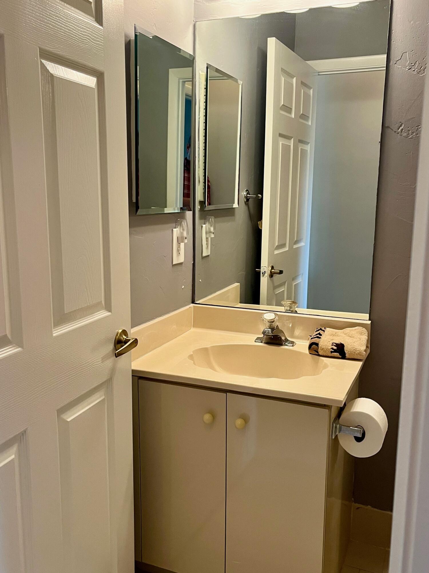 8300 Waterline Drive, Unit 105 Boynton Beach, FL 33472 - Photo 16 of 20 a bathroom with a sink and a mirror