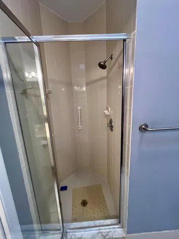 a bathroom with a glass door shower