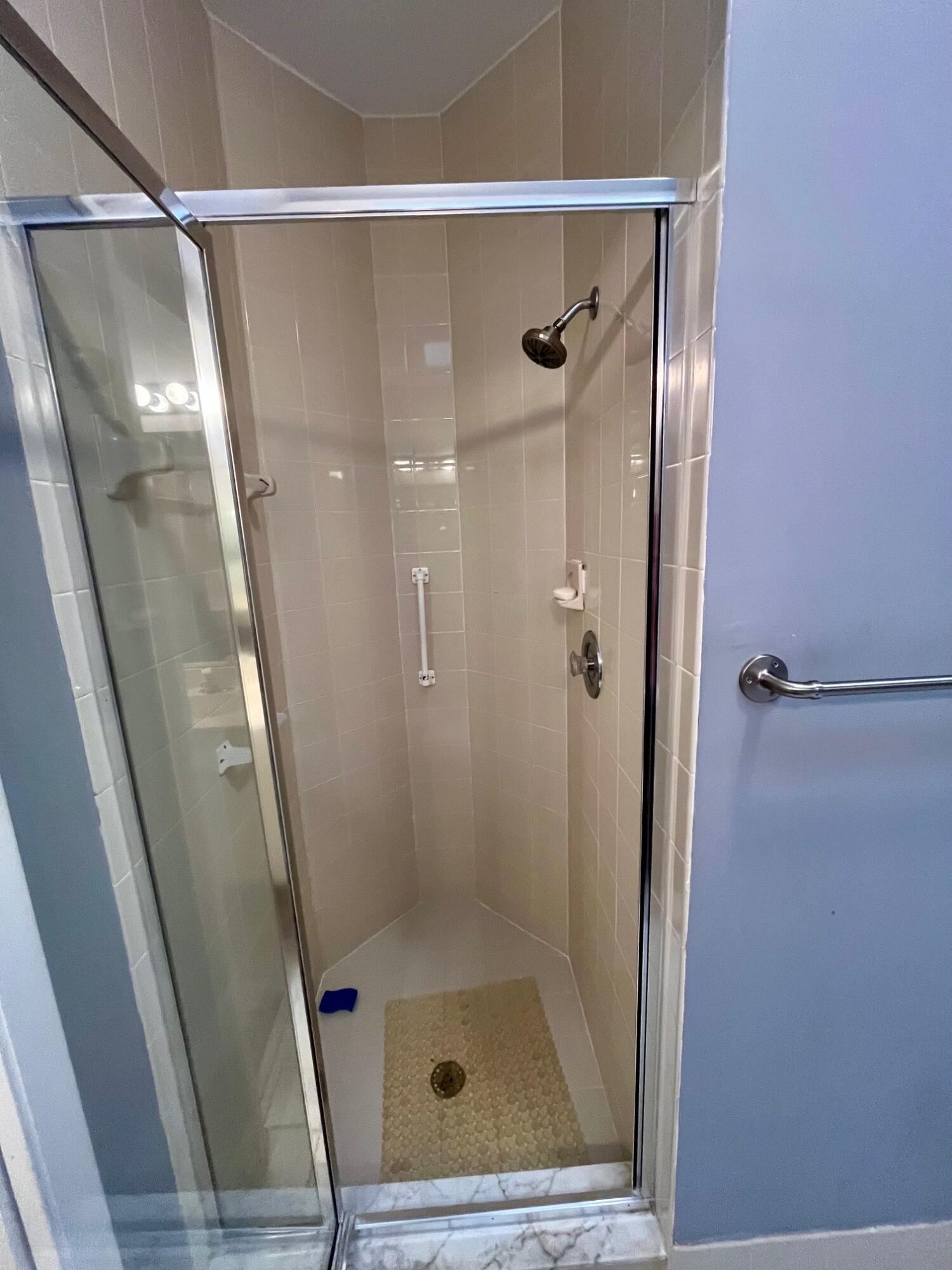 8300 Waterline Drive, Unit 105 Boynton Beach, FL 33472 - Photo 18 of 20 a bathroom with a glass door shower