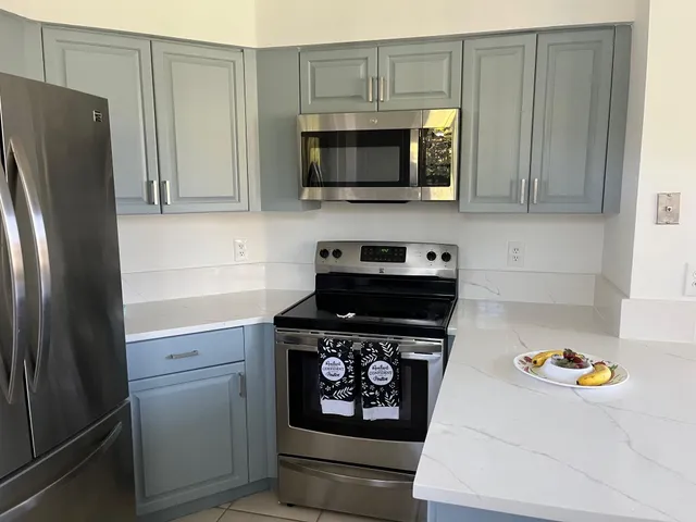 a kitchen with stainless steel appliances a stove a microwave and refrigerator