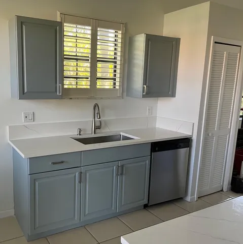 a kitchen with a sink and a mirror