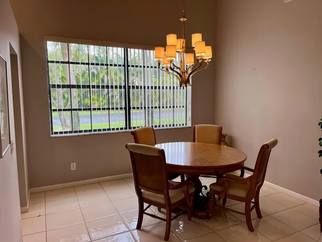 a view of a dining room with furniture and a chandelier