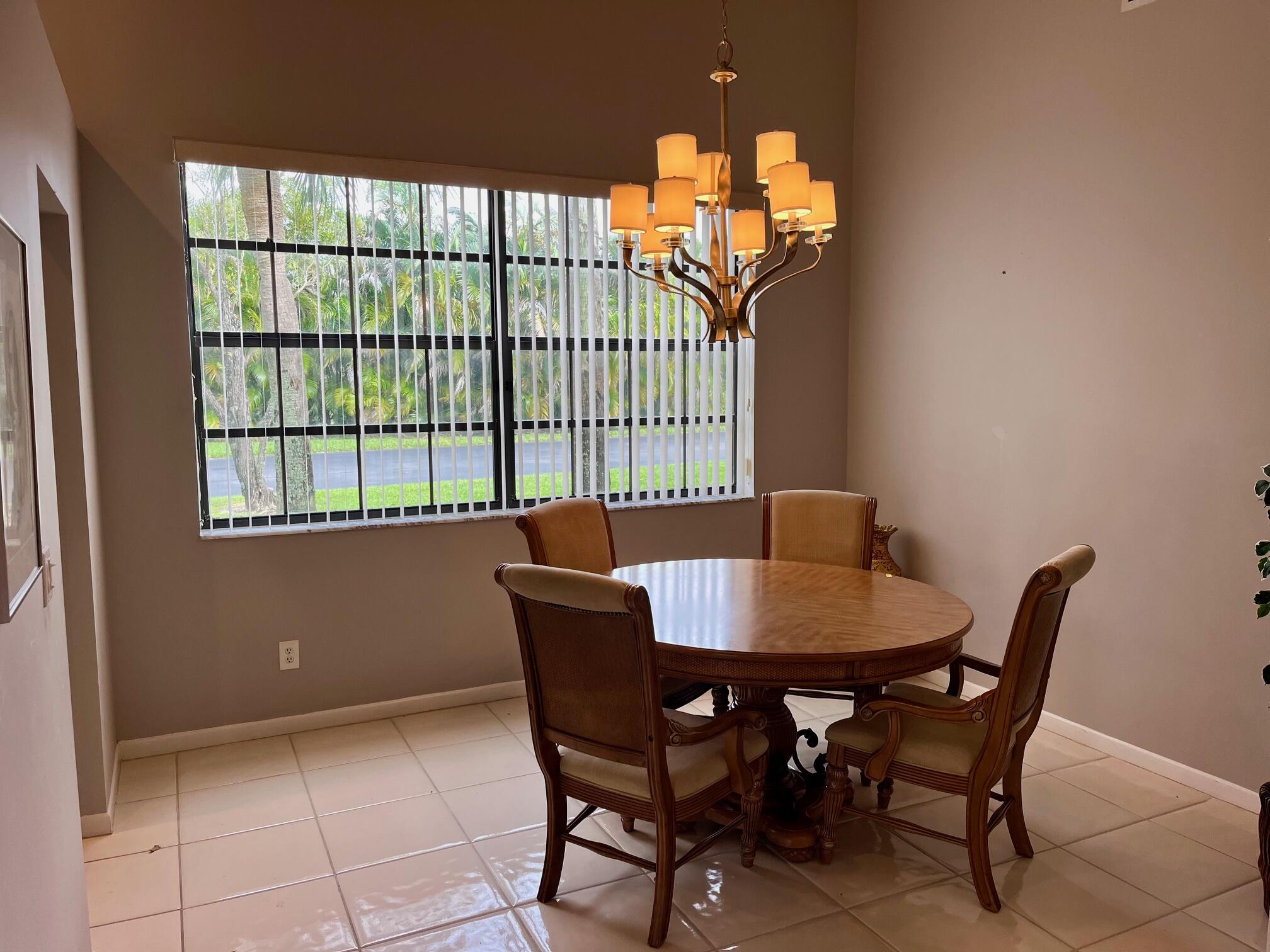 8300 Waterline Drive, Unit 105 Boynton Beach, FL 33472 - Photo 6 of 20 a view of a dining room with furniture and a chandelier