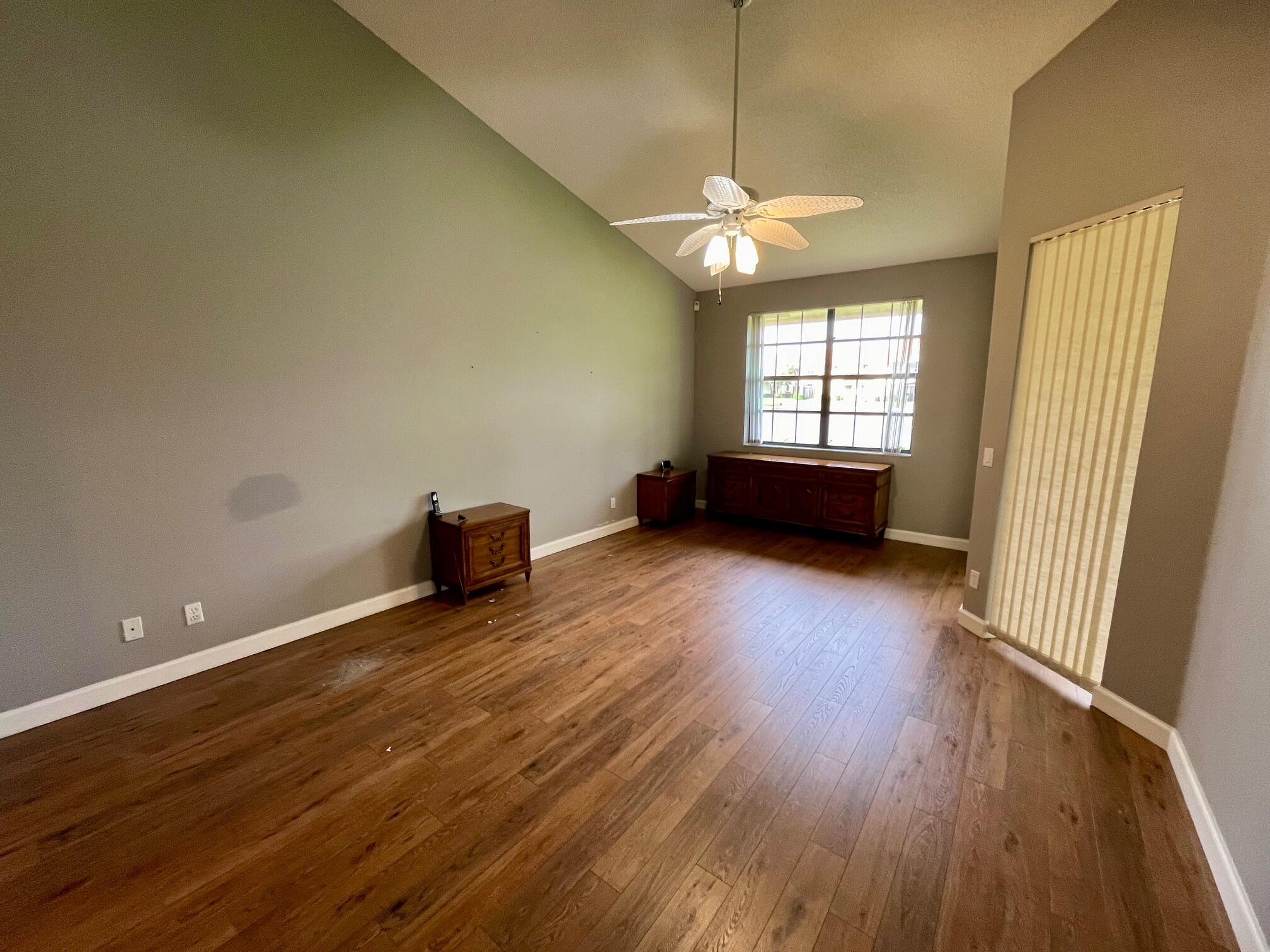 8300 Waterline Drive, Unit 105 Boynton Beach, FL 33472 - Photo 8 of 20 an empty room with wooden floor and windows