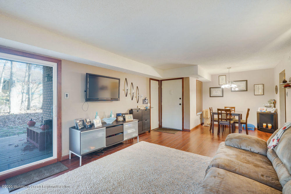 89 Northrup Drive, Unit 75 Brick, NJ 08724 - Photo 12 of 24 a living room with furniture and a flat screen tv