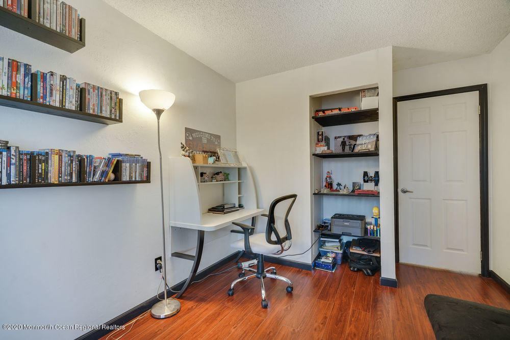 89 Northrup Drive, Unit 75 Brick, NJ 08724 - Photo 13 of 24 a view of a workspace with furniture and a bookshelf