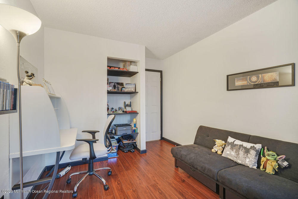 89 Northrup Drive, Unit 75 Brick, NJ 08724 - Photo 14 of 24 a living room with furniture and wooden floor