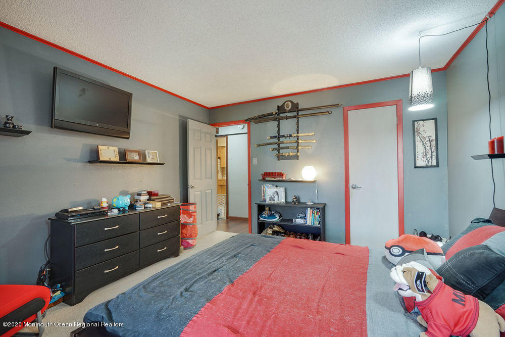 89 Northrup Drive, Unit 75 Brick, NJ 08724 - Photo 18 of 24 a bed room with a bed window and a television