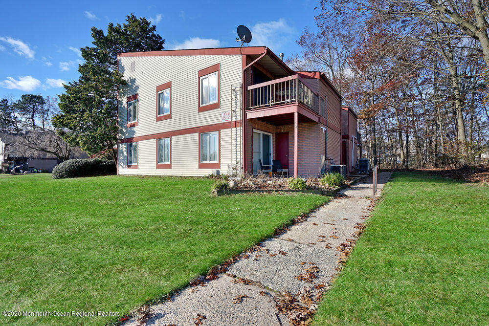 89 Northrup Drive, Unit 75 Brick, NJ 08724 - Photo 23 of 24 a front view of a house with a yard