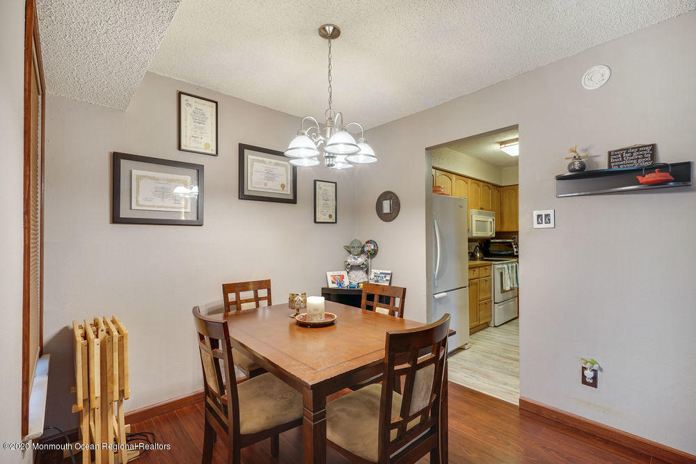 89 Northrup Drive, Unit 75 Brick, NJ 08724 - Photo 4 of 24 a view of a dining room with furniture and wooden floor