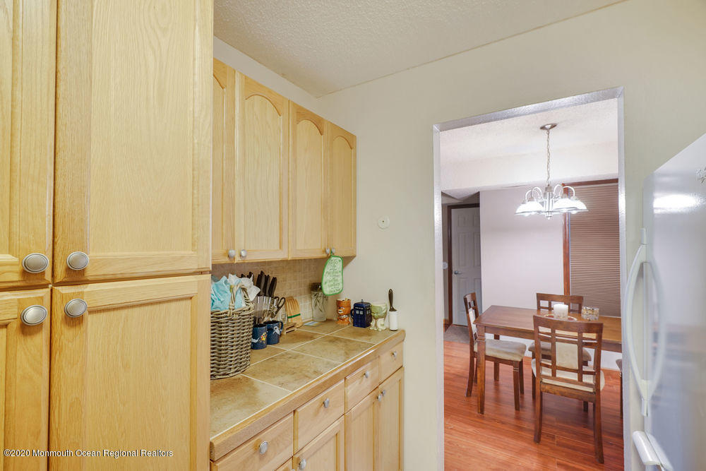 89 Northrup Drive, Unit 75 Brick, NJ 08724 - Photo 5 of 24 a kitchen with a sink cabinets and wooden floor