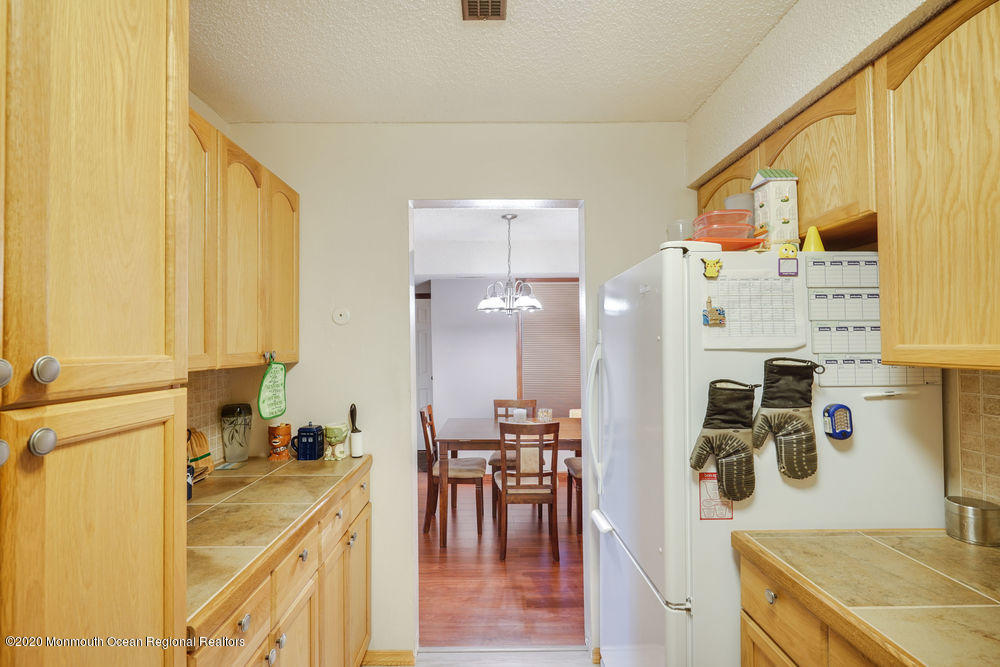 89 Northrup Drive, Unit 75 Brick, NJ 08724 - Photo 6 of 24 a view of kitchen with furniture and wooden floor