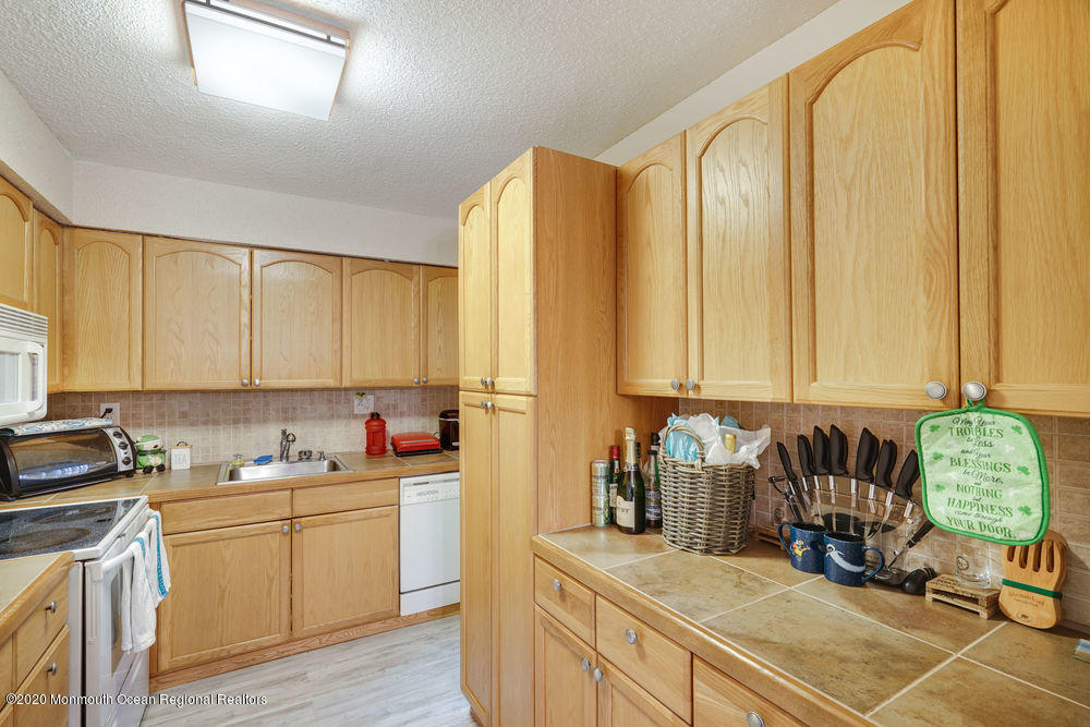 89 Northrup Drive, Unit 75 Brick, NJ 08724 - Photo 8 of 24 a kitchen with a sink and cabinets