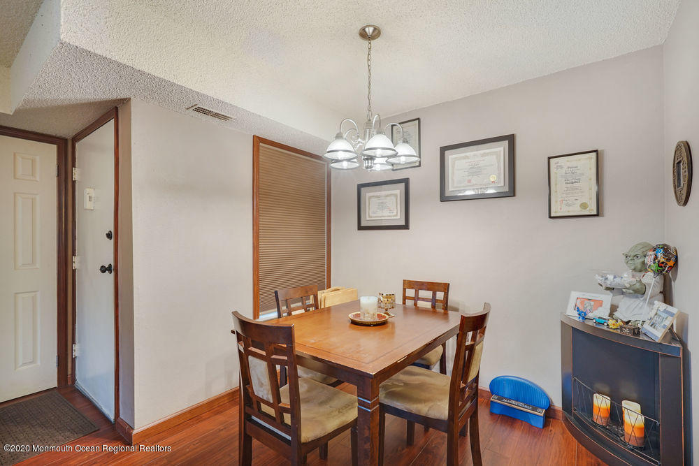 89 Northrup Drive, Unit 75 Brick, NJ 08724 - Photo 10 of 24 a view of a dining room with furniture and wooden floor