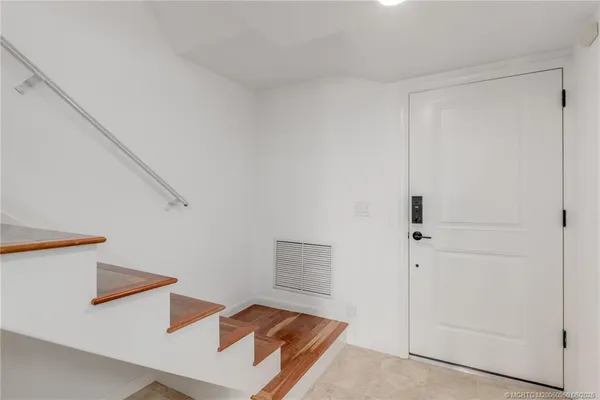 a living room with furniture a flat screen tv and a large window