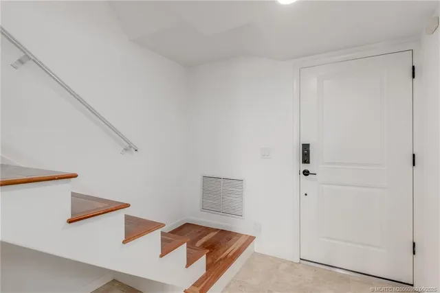 a living room with furniture a flat screen tv and a large window