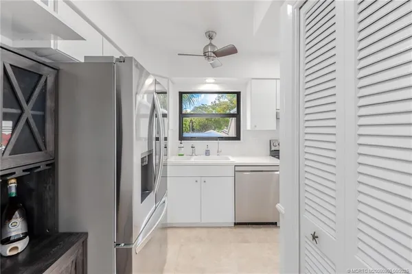 a kitchen with a sink and refrigerator