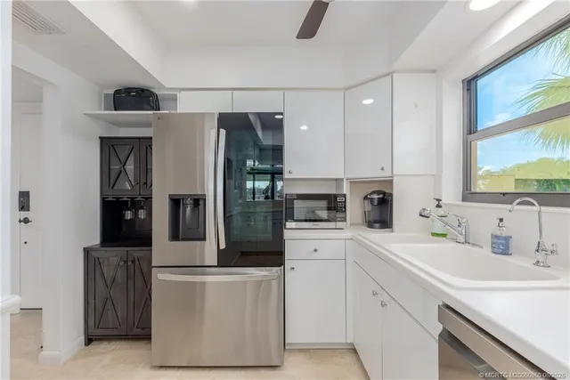 a view of a kitchen with furniture and wooden floor