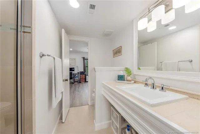 a bedroom with furniture and a wooden floor