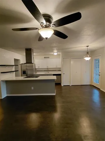 a kitchen with kitchen island a sink appliances and cabinets