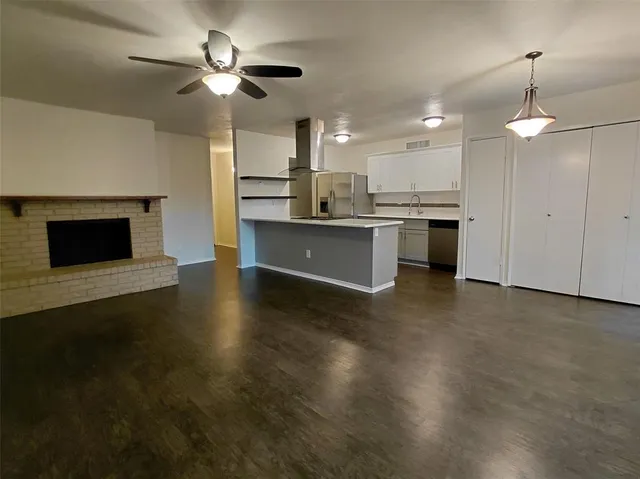 a kitchen with kitchen island a stove a sink and a microwave