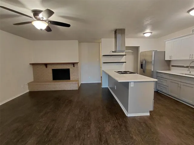 a view of a kitchen with a sink and a refrigerator