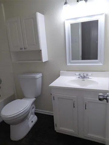a bathroom with a toilet sink and shower
