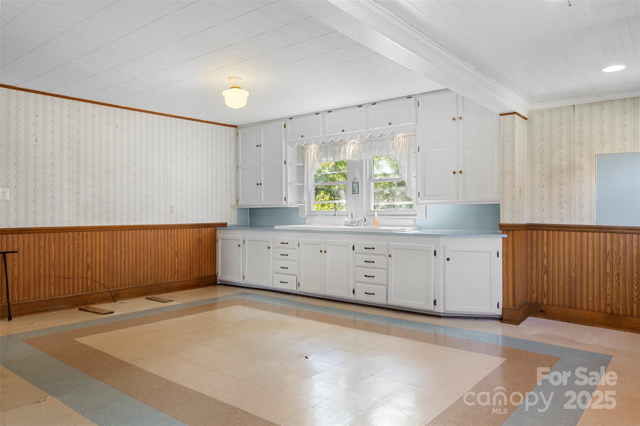 4601 Mooresville Road Kannapolis, NC 28081 - Photo 11 of 33 a view of a kitchen with cabinets and a wooden floor