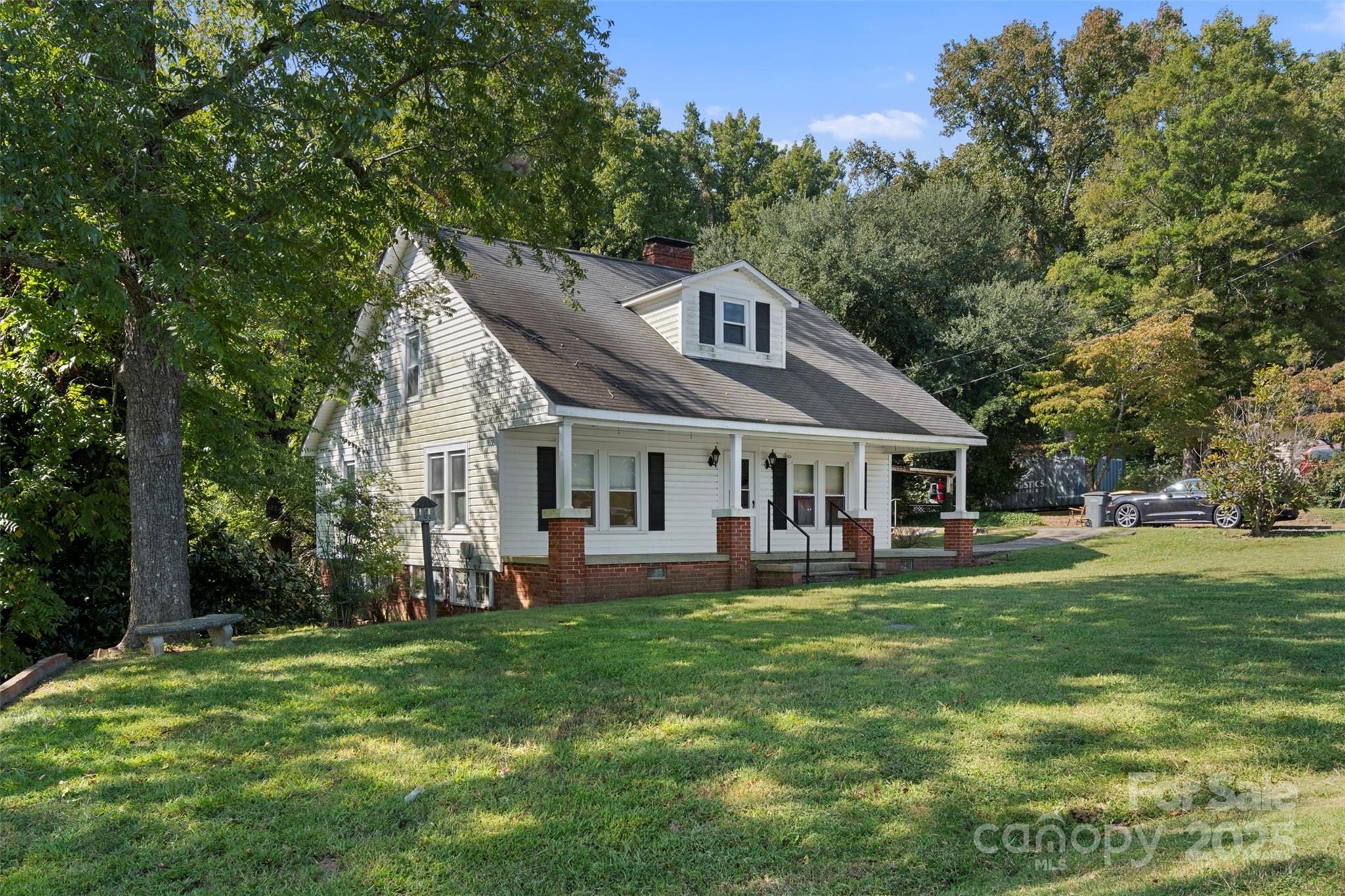 4601 Mooresville Road Kannapolis, NC 28081 - Photo 3 of 33 a front view of a house with a garden and trees
