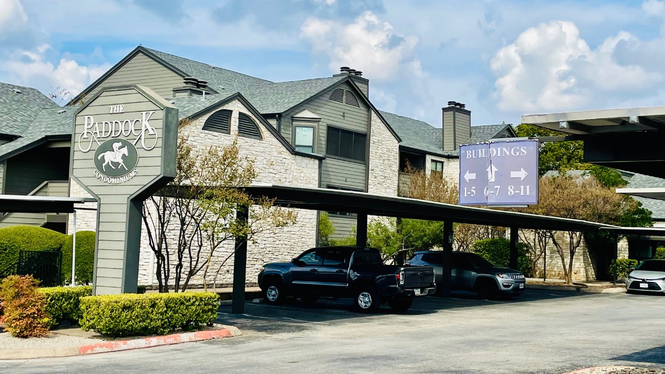 a view of a car park in front of house