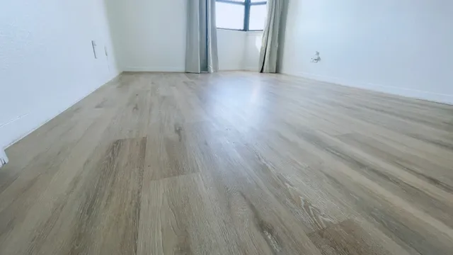 a view of a room with wooden floor