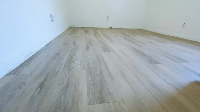 a view of a room with wooden floor