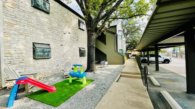 a front view of a house with swing and stairs
