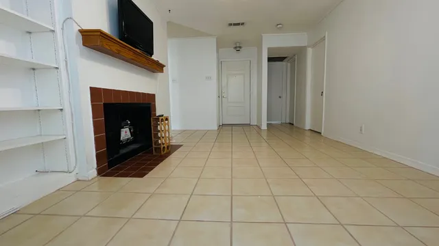 a view of an empty room with a fireplace