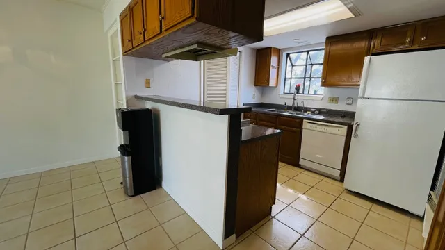 a kitchen with stainless steel appliances granite countertop a refrigerator and a stove