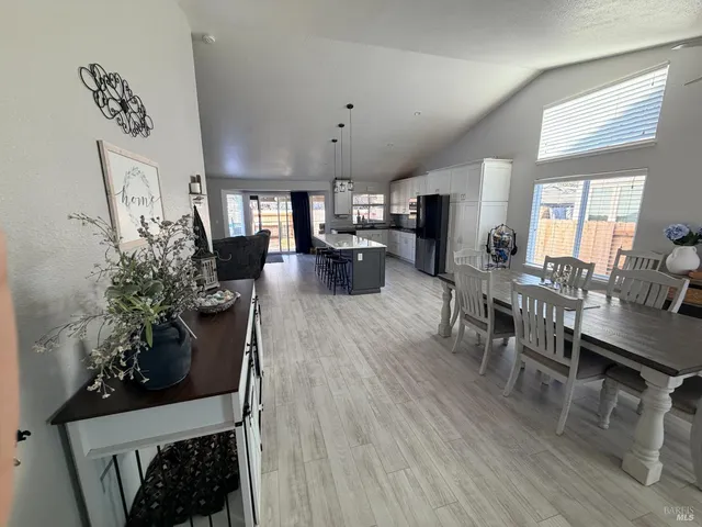 a living room with furniture potted plant and flat screen tv