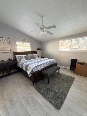 a spacious bedroom with a bed and a chandelier