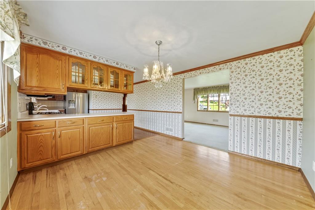 1004 Fiddleback Drive McKees Rocks, PA 15136 - Photo 11 of 25 a kitchen with granite countertop a stove a sink and a refrigerator