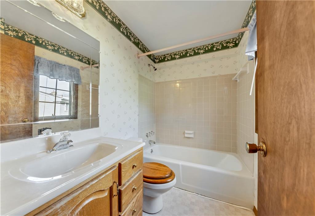 1004 Fiddleback Drive McKees Rocks, PA 15136 - Photo 16 of 25 a bathroom with a sink mirror toilet and bathtub