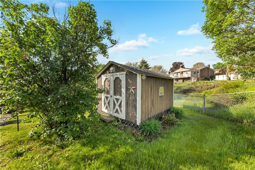 1004 Fiddleback Drive McKees Rocks, PA 15136 - Photo 22 of 25 a view of a wooden house with a yard